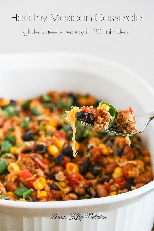 Picture of this healthy Mexican casserole in a white baking dish and a  close up of a fork filled with some of the casserole and the title of the recipe up top.