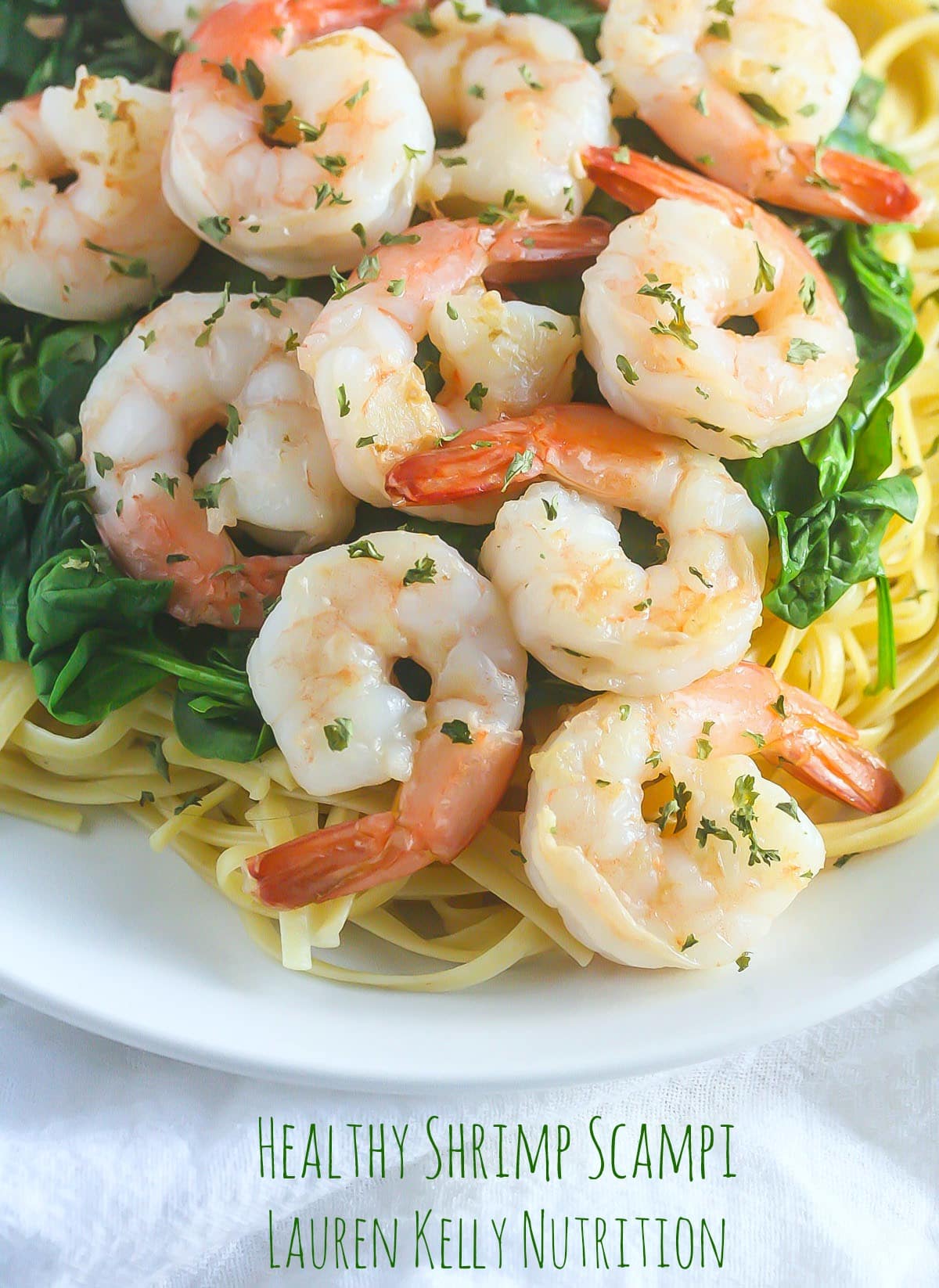 Healthy Shrimp Scampi close up on top of spinach.
