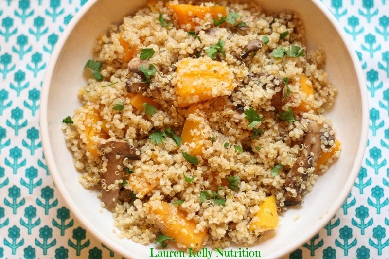 Healthy Mushroom and Squash Quinoa Risotto recipe, a high-protein, one-pot gluten-free dinner filled with butternut squash and sliced mushrooms in a white bowl.