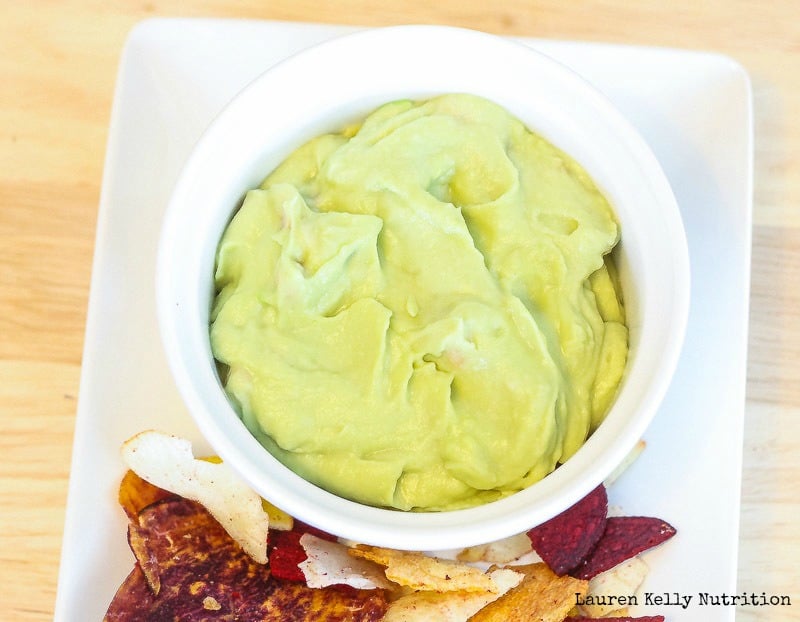 Close up of Avocado Hummus in a white bowl.