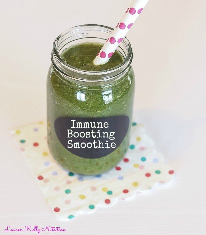 Immune boosting smoothie in a clear mason jar with pink and white polka dots.