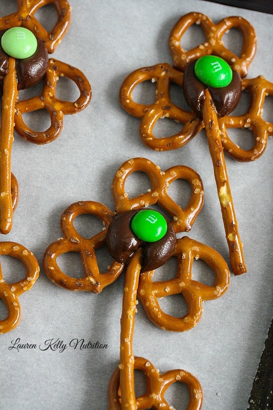 Shamrock pretzels on a baking sheet.