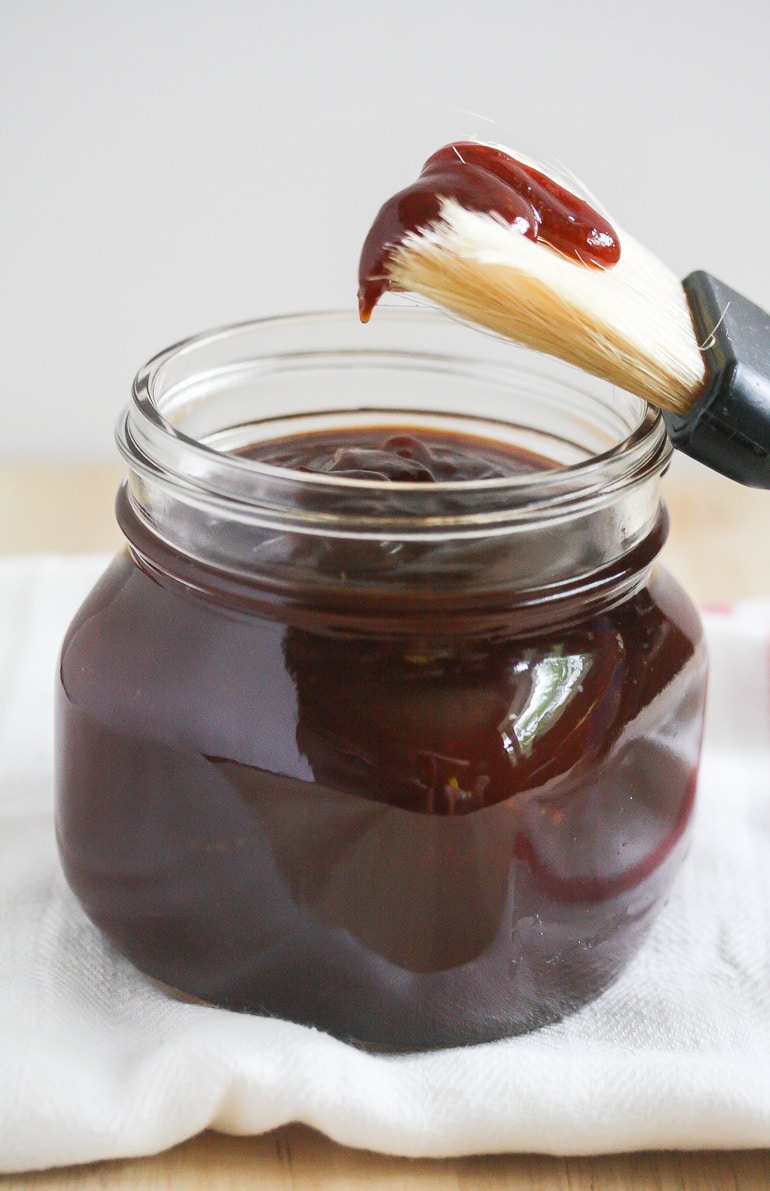 Homemade Barbecue Sauce in a clear jar with a brush coming out.