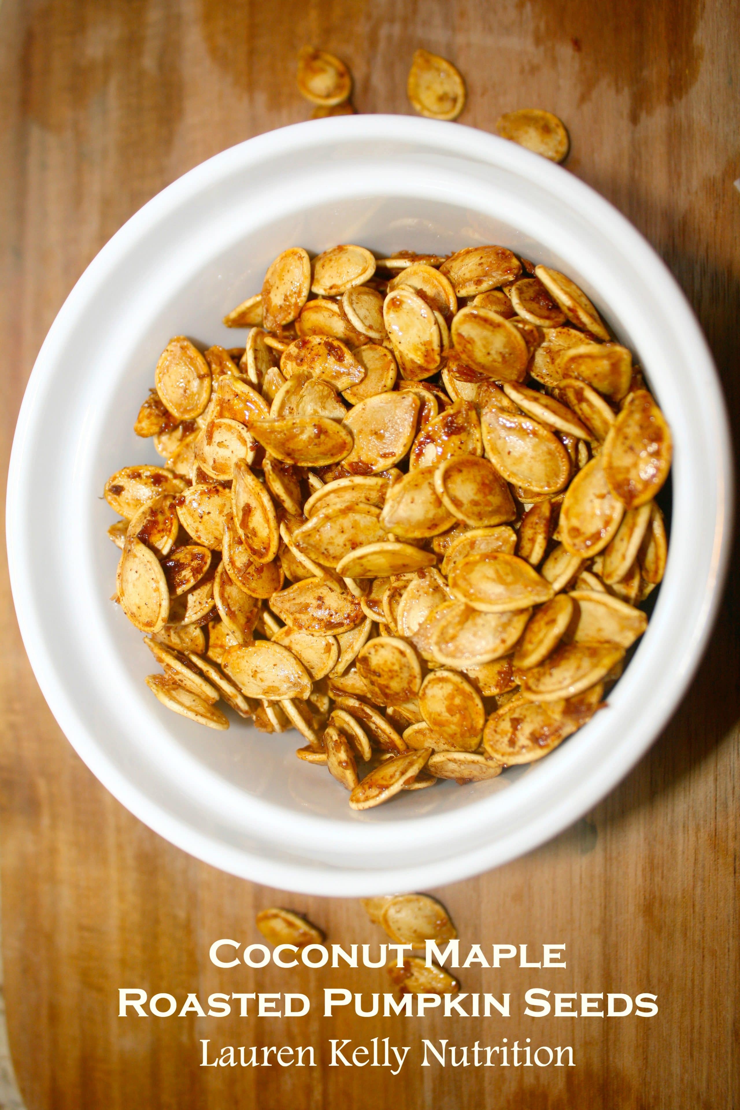 Coconut Maple Roasted Pumpkin Seeds in a white bowl.