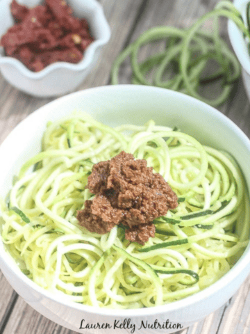Zucchini Noodles with sundried tomato pesto in a bowl.