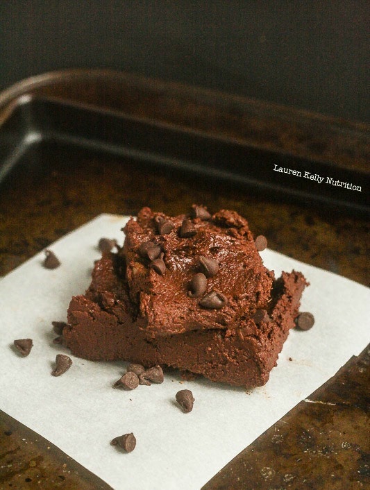 Stacked pumpkin fudge on a baking sheet.