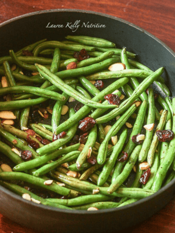 Picture of balsamic glazed green beans with cranberries and almonds in a pot.