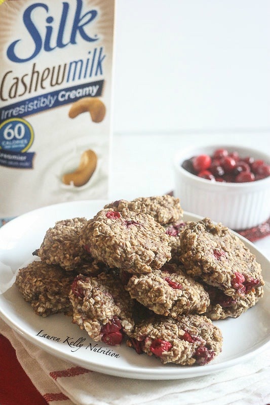 Cranberry Orange Breakfast Cookies on a white plate with cashew milk behind the plate.