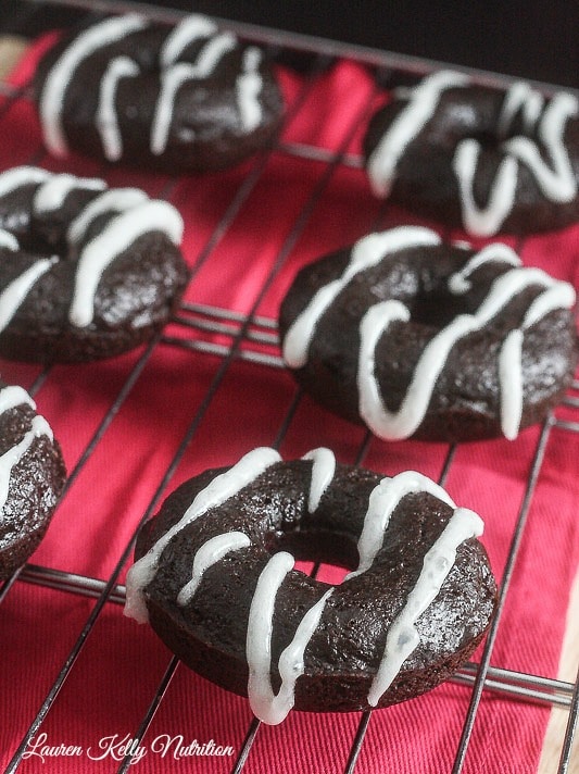 Hot Chocolate Doughnuts with Marshmallow Glaze on a wire rack.