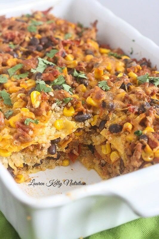 Mexican Quinoa Lasagna in a white casserole dish with a slice taken out of it.