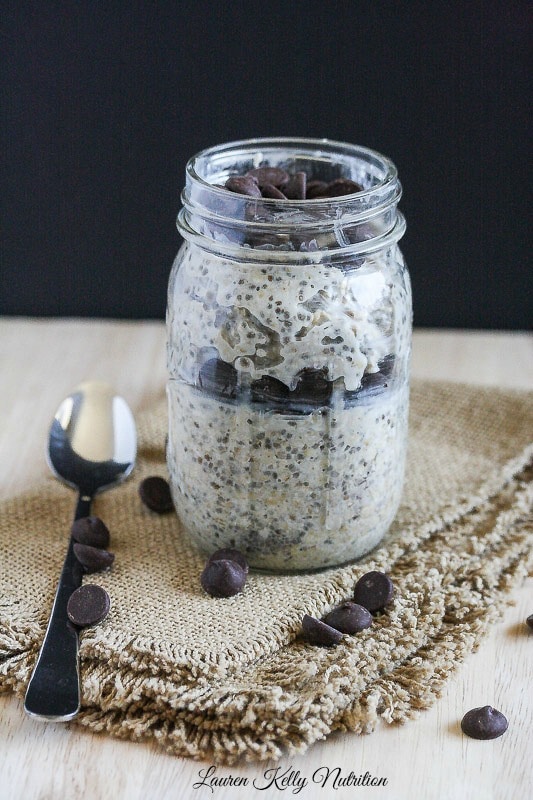 Creamy Chocolate Chip Overnight Oats in a mason jar with a spoon next to it.
