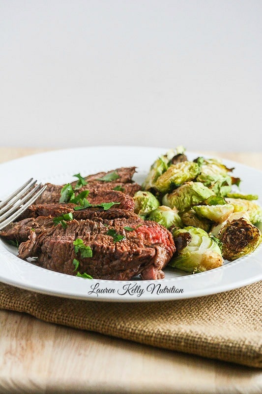 Ginger Teriyaki Filet  with brussels sprouts on a plate with a fork.