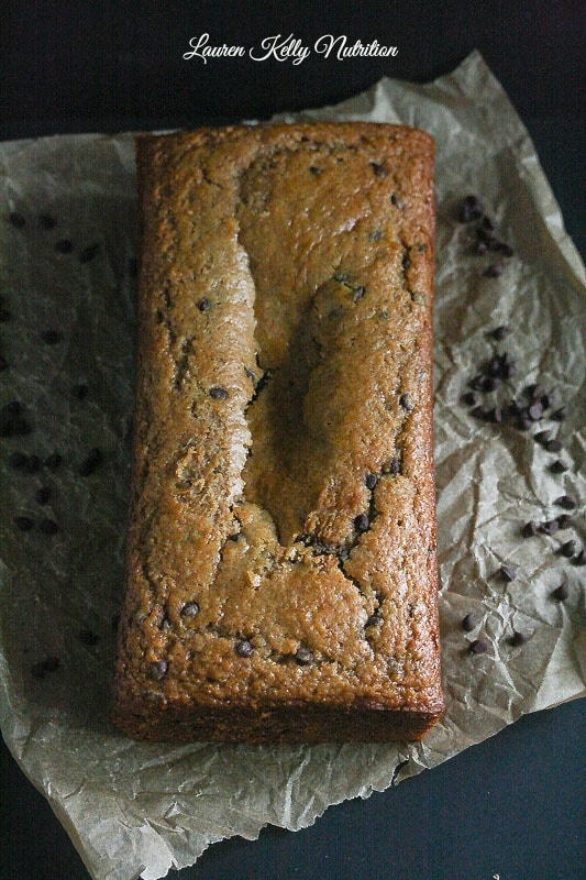 Peanut butter chocolate chip banana bread uncut on parchment paper.