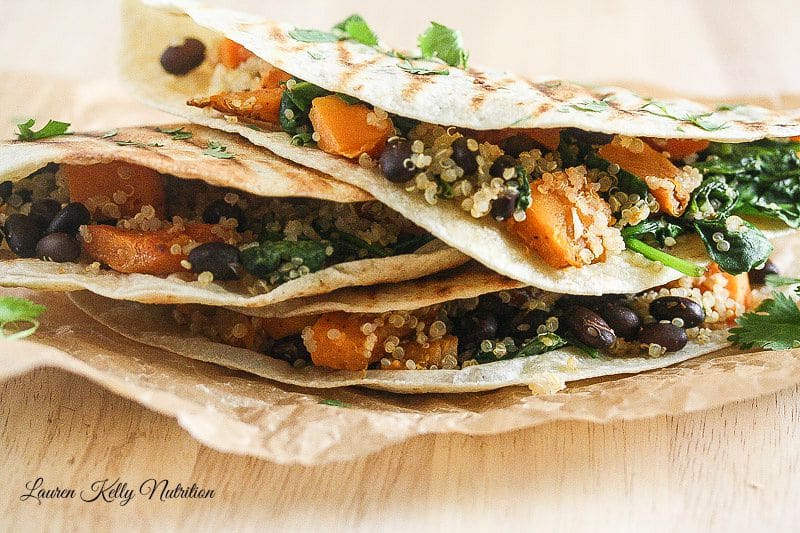 Close up Butternut Squash Black Bean & Quinoa Quesadillas stacked on top of each other.