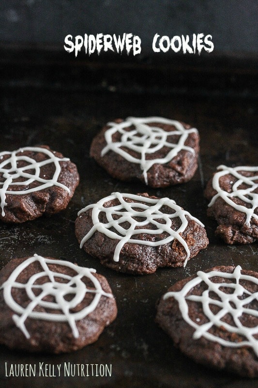 Picture of chocolate cookies with spiderweb white icing on top and the text title in the top of the picture.