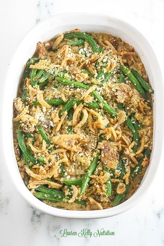 Overhead picture of cooked green bean quinoa casserole in a white baking dish.