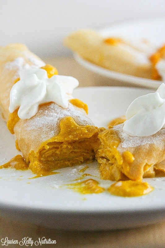 Close up of pumpkin filled crepes cut in half.