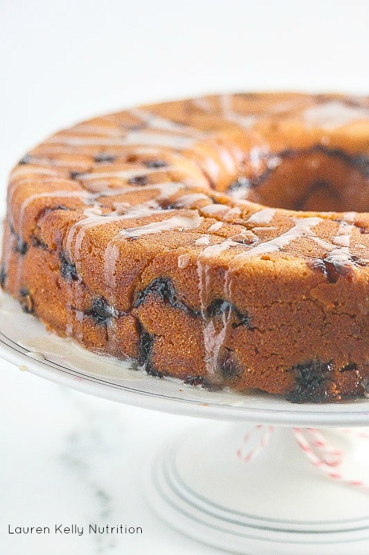 Close up of Cranberry Cake  on a white cake plate.