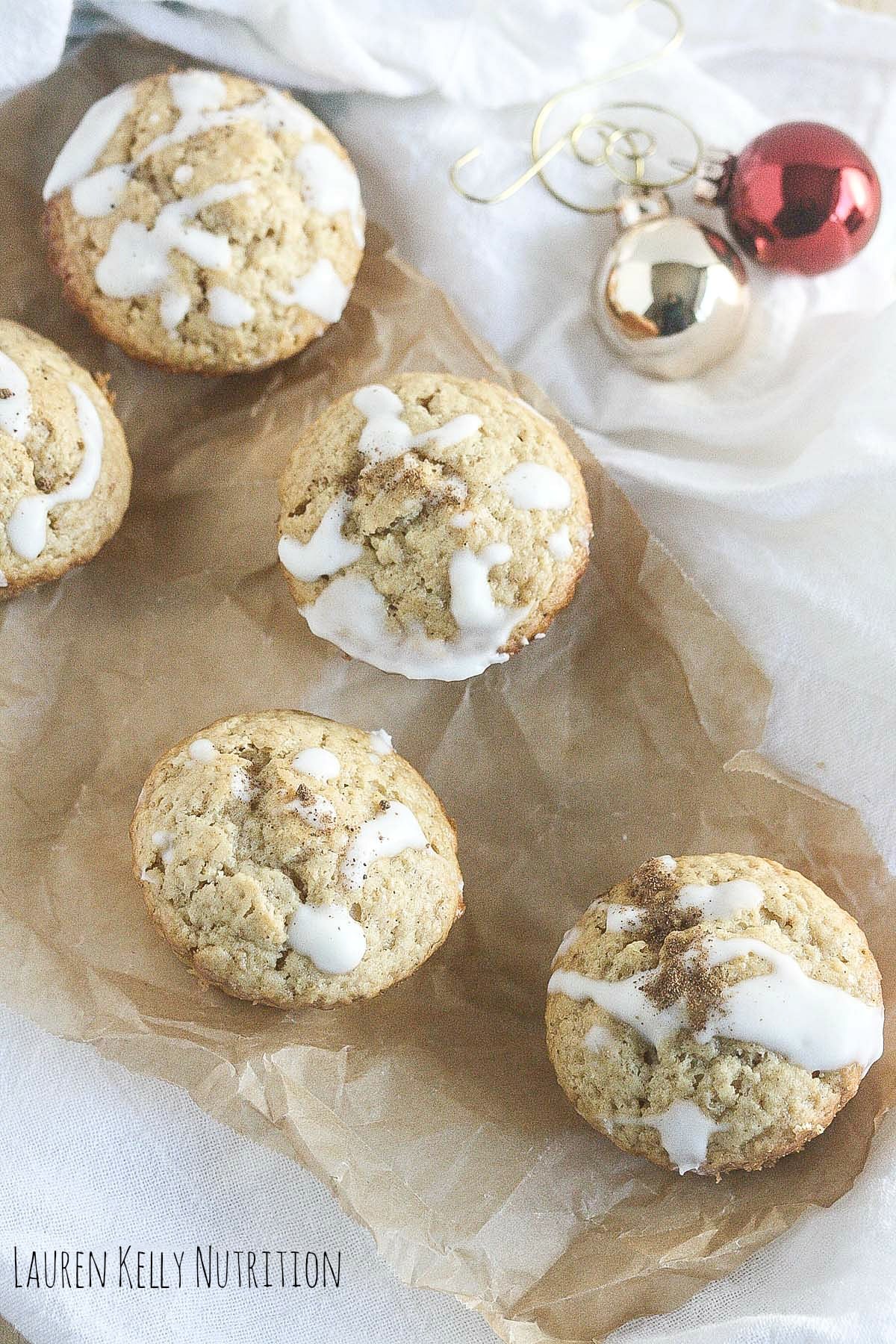 Overhead picture of Eggnog Muffins on parchment paper with decorations in the corner.