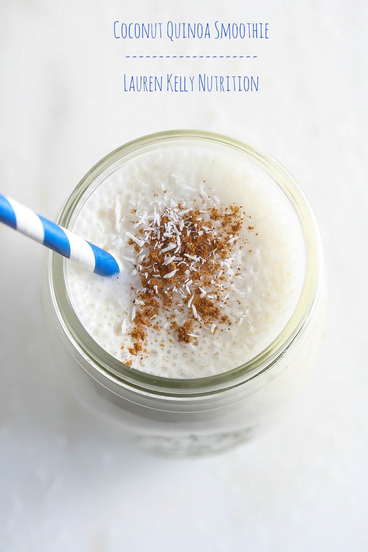 Overhead picture of coconut quinoa smoothie with a blue and white striped straw.