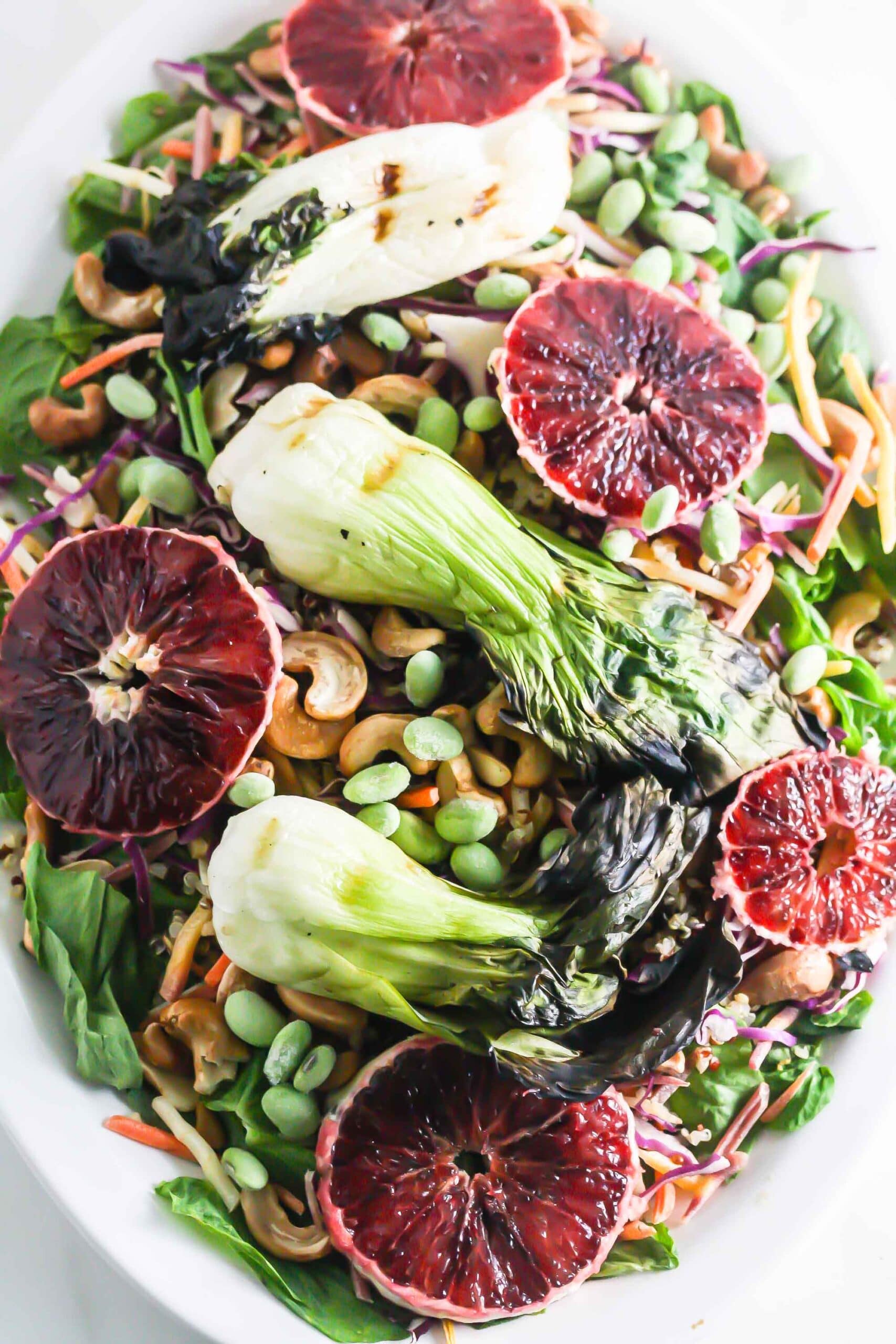 Grilled Baby Bok Choy Salad with Honey Miso Dressing on a white plate.