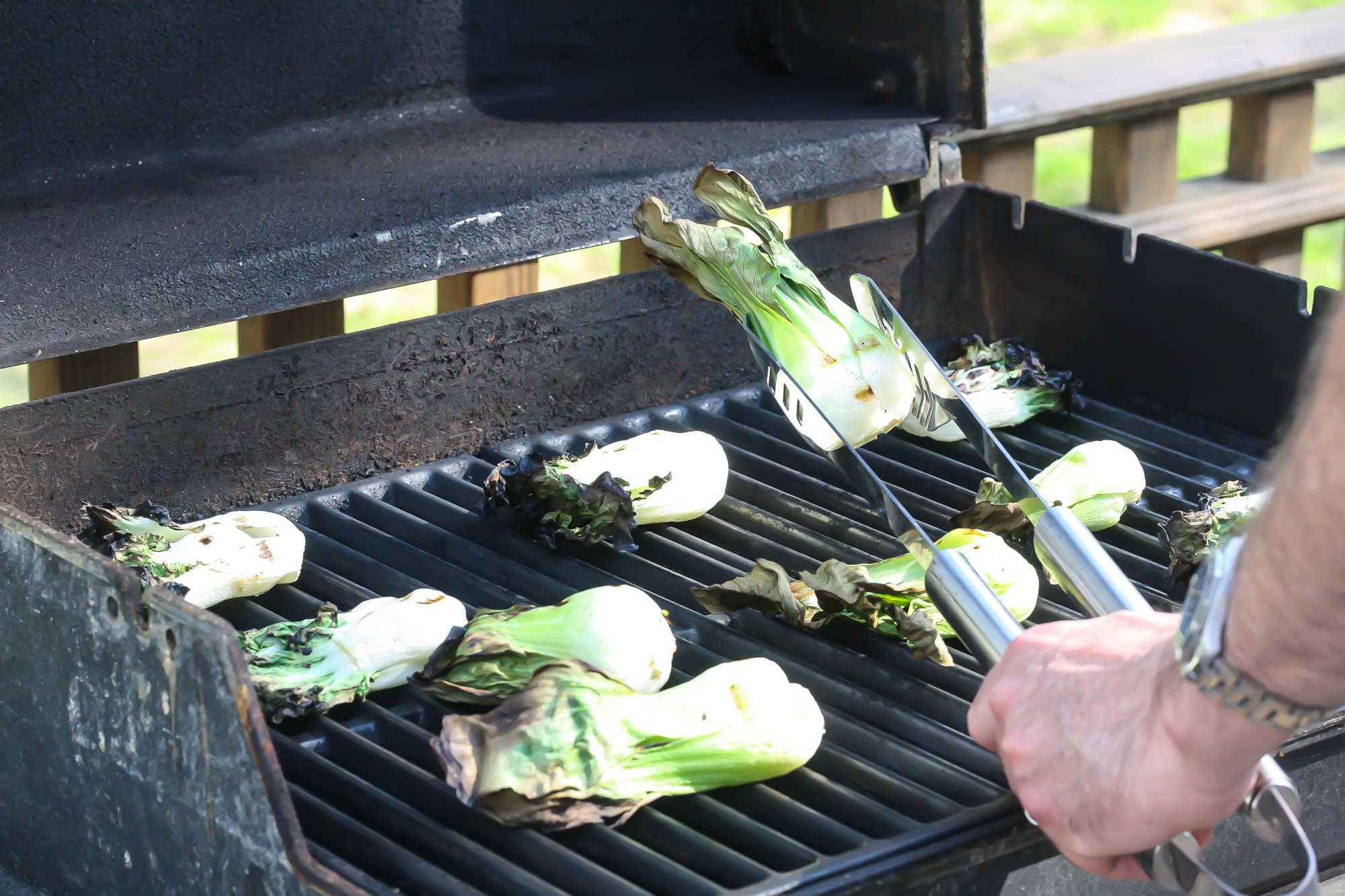 Grilled Baby Bok Choy on a lit grill.