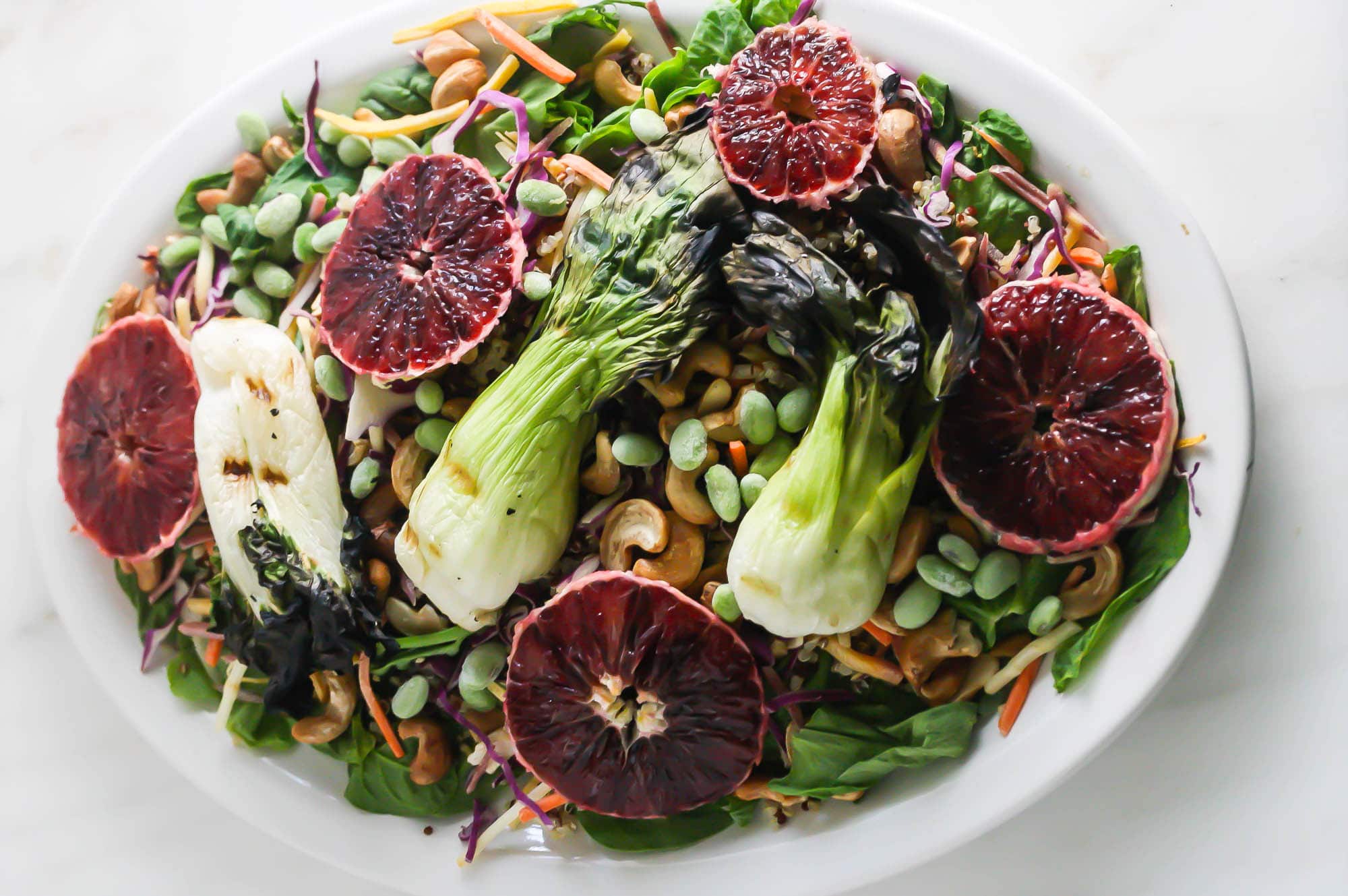 Grilled Baby Bok Choy Salad with Honey Miso Dressing on a plate horizontal.