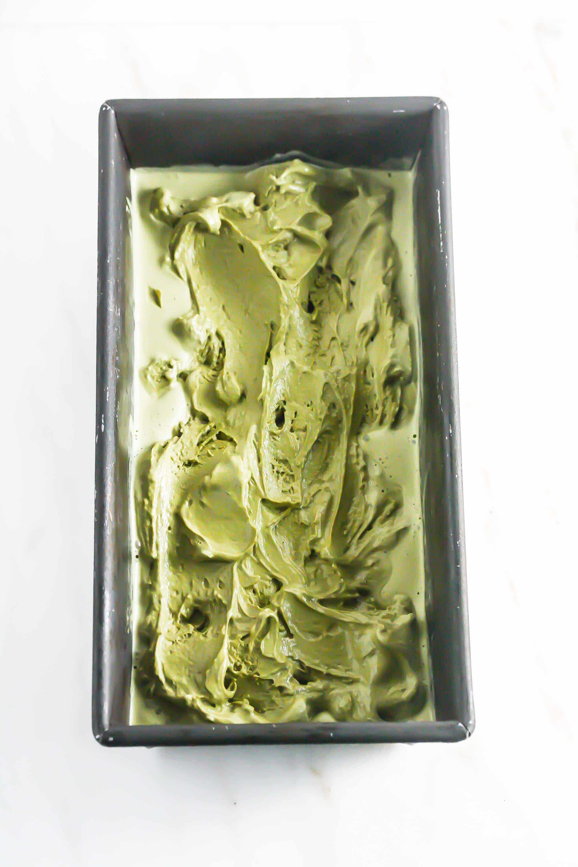 Overhead picture of matcha ice cream in a rectangular baking pan.