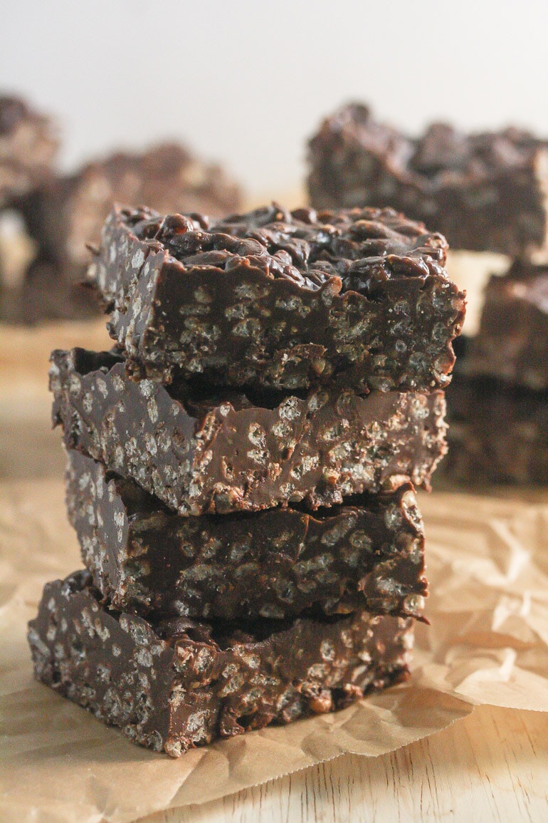 Three no bake chocolate peanut butter bars  in a stack.