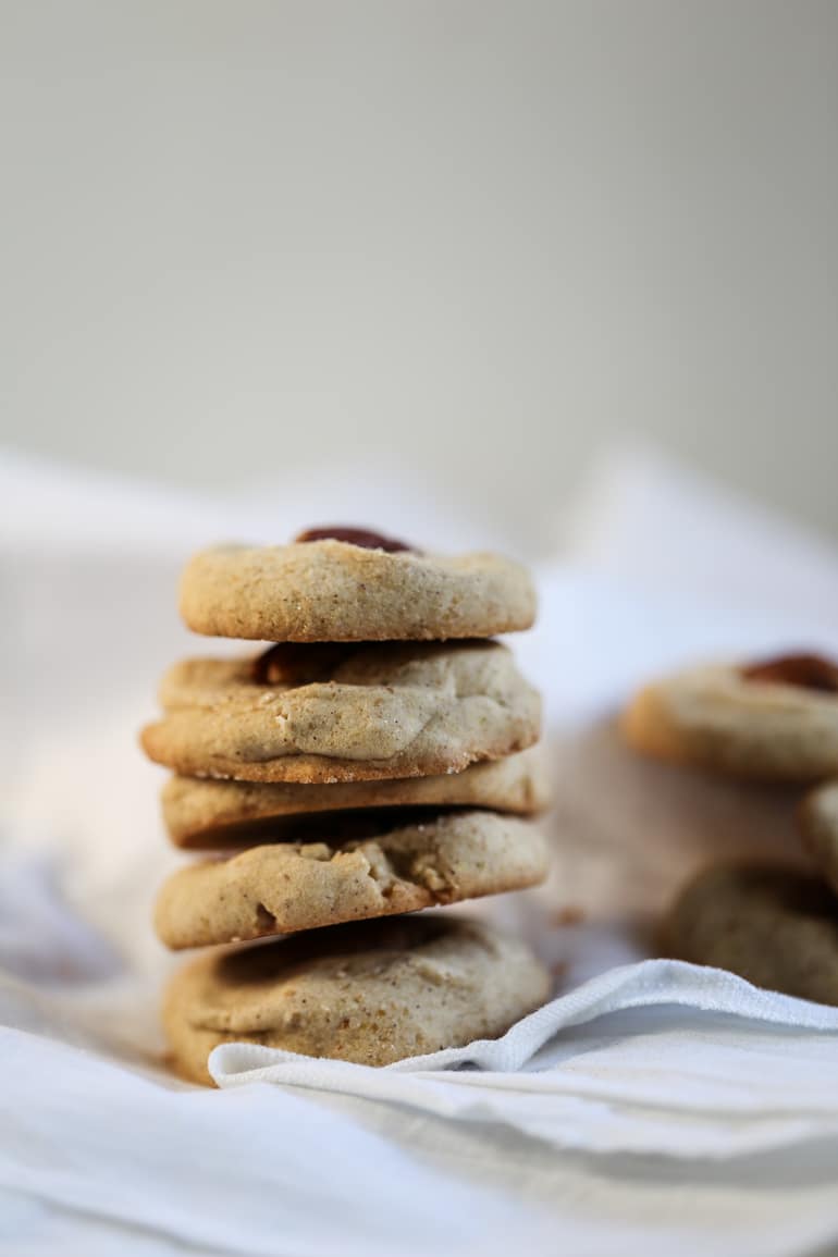 A stack of butter pecan cookies on a white cloth.
