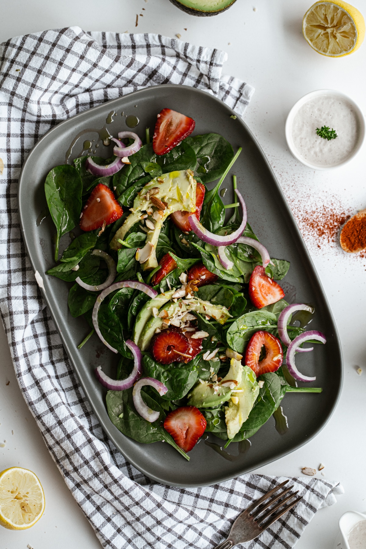 Strawberry Spinach Salad on a dark oval plate.
