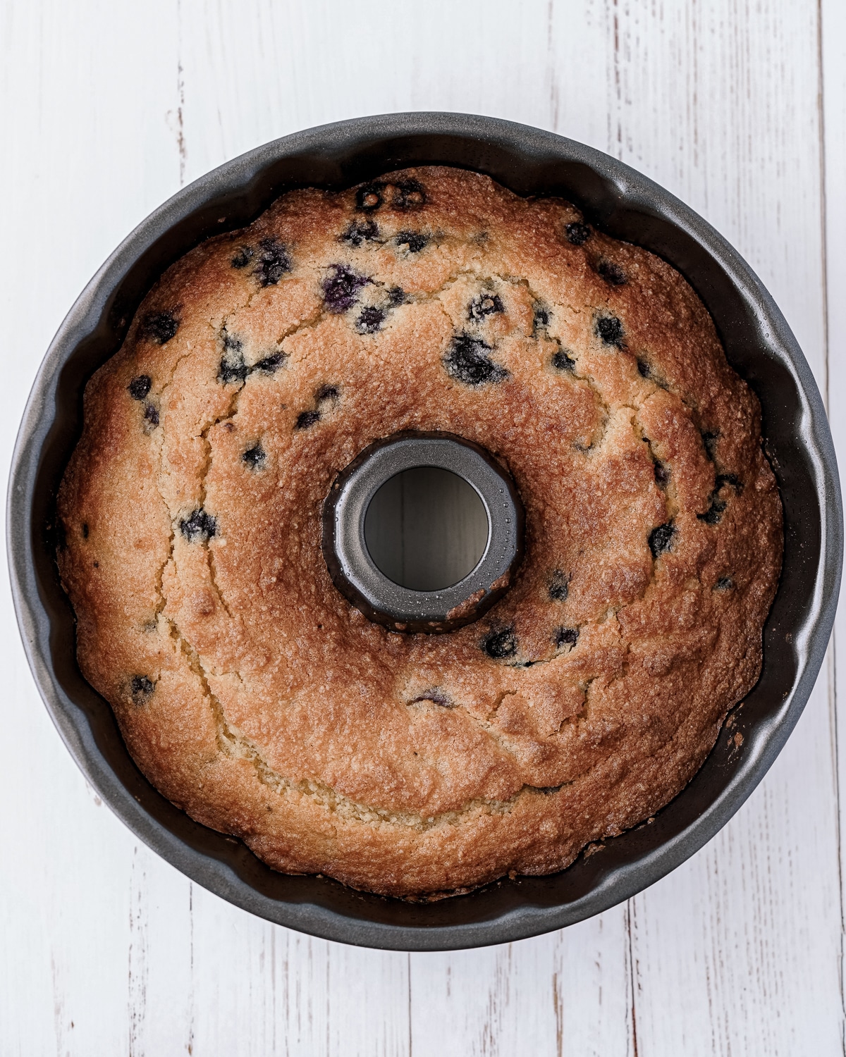 Overhead picture of cooked lemon blueberry cake in bundt pan.