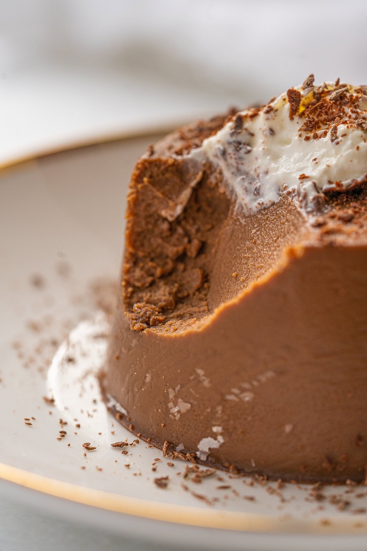 Close up picture of chocolate Panna Cotta with a spoon full taken off the top.