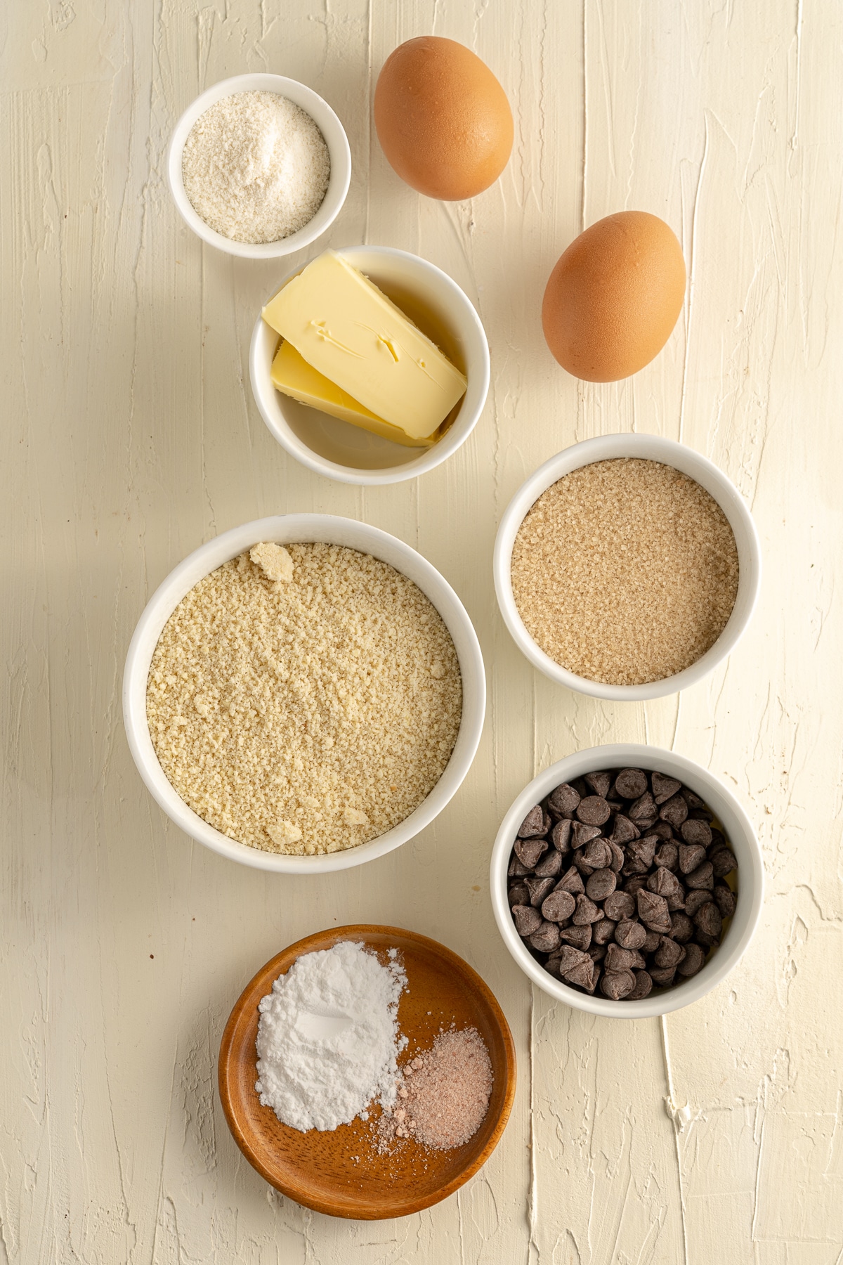 Overhead picture of the seven ingredients on a white background, all in small individual white bowls. 