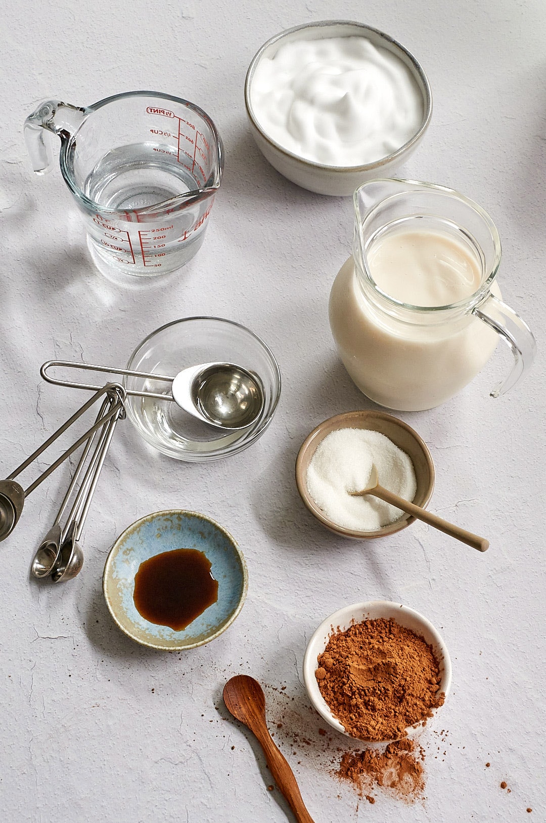 Overhead picture of all the individual ingredients in small bowls and glass pitchers and bowls.