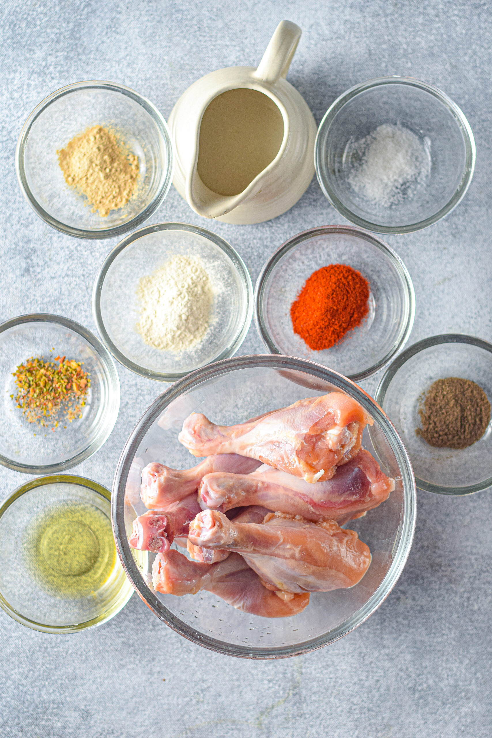 Ingredients for instant pot chicken drumsticks in small individual glass bowls.