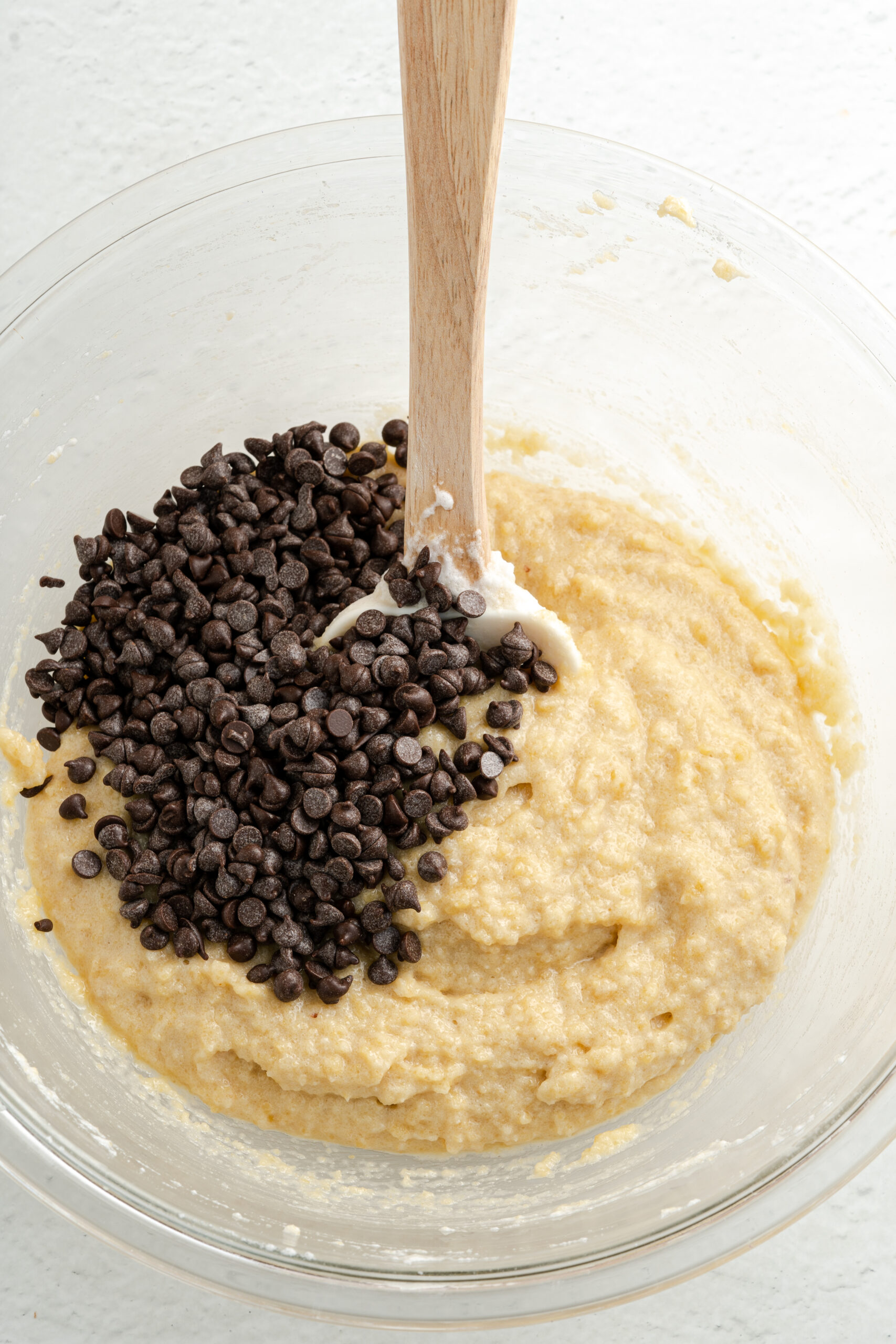 Batter for muffins with chocolate chips in mixing bowl.