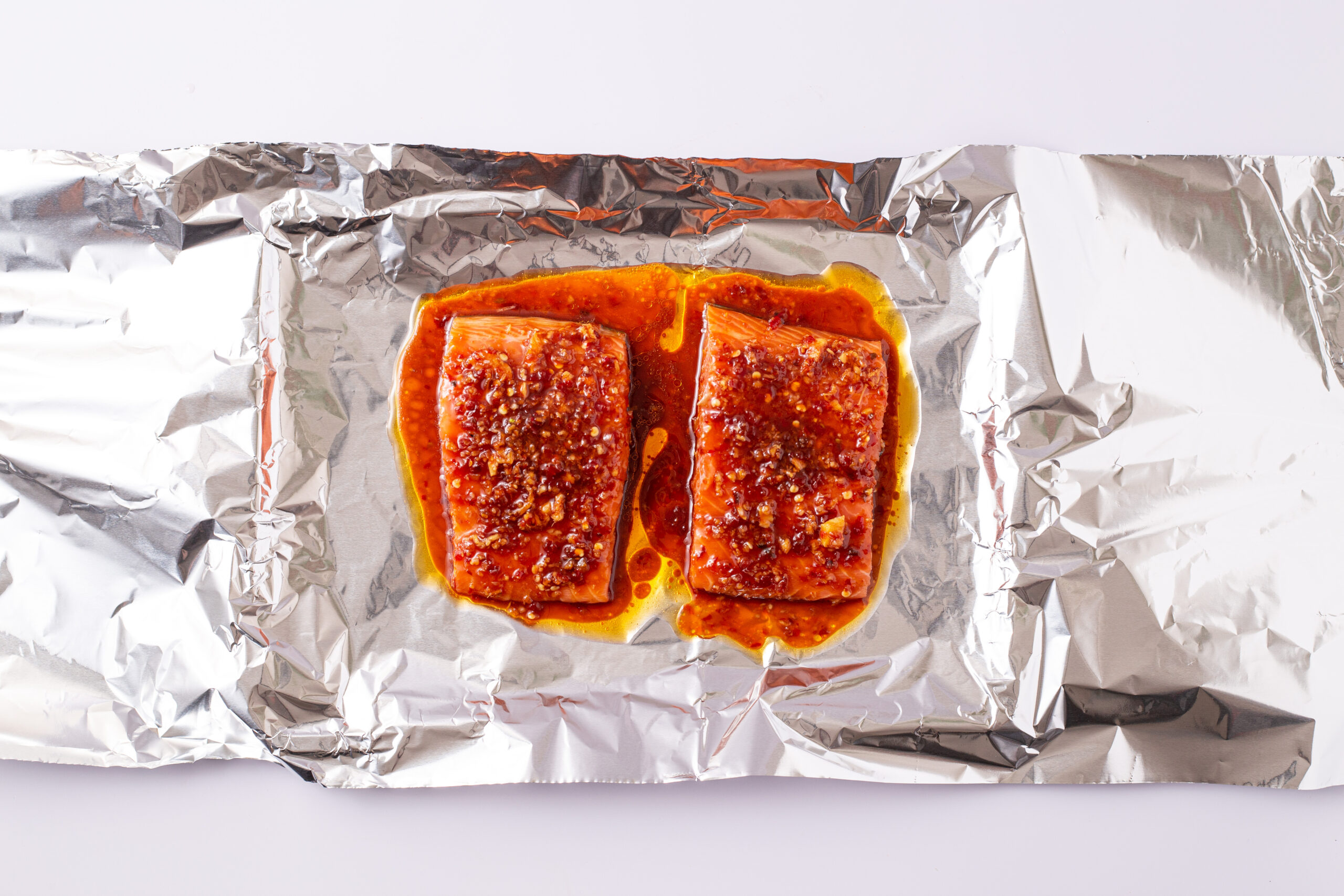 Cooked salmon on a prepared baking sheet.