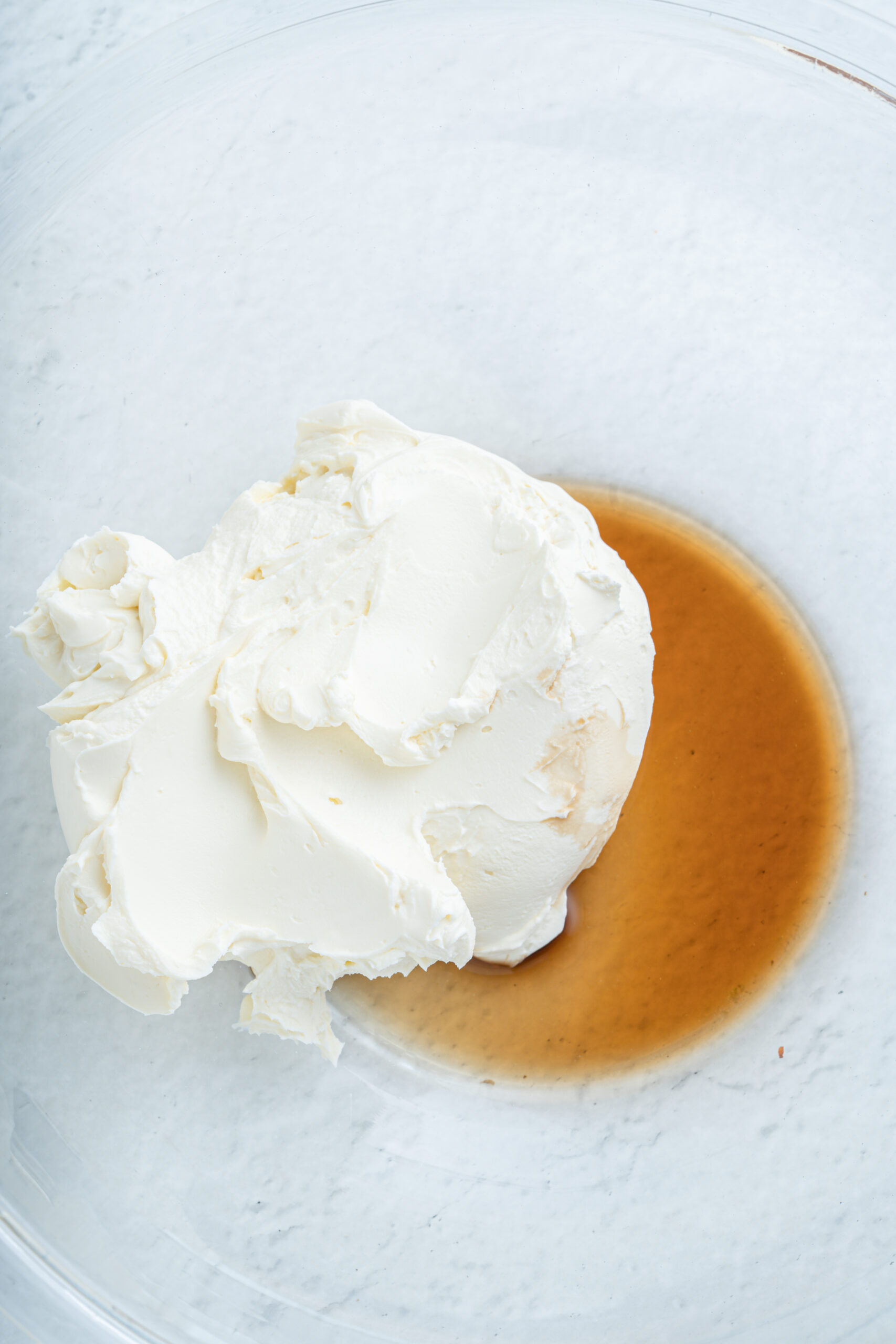Cream cheese and vanilla in a bowl.