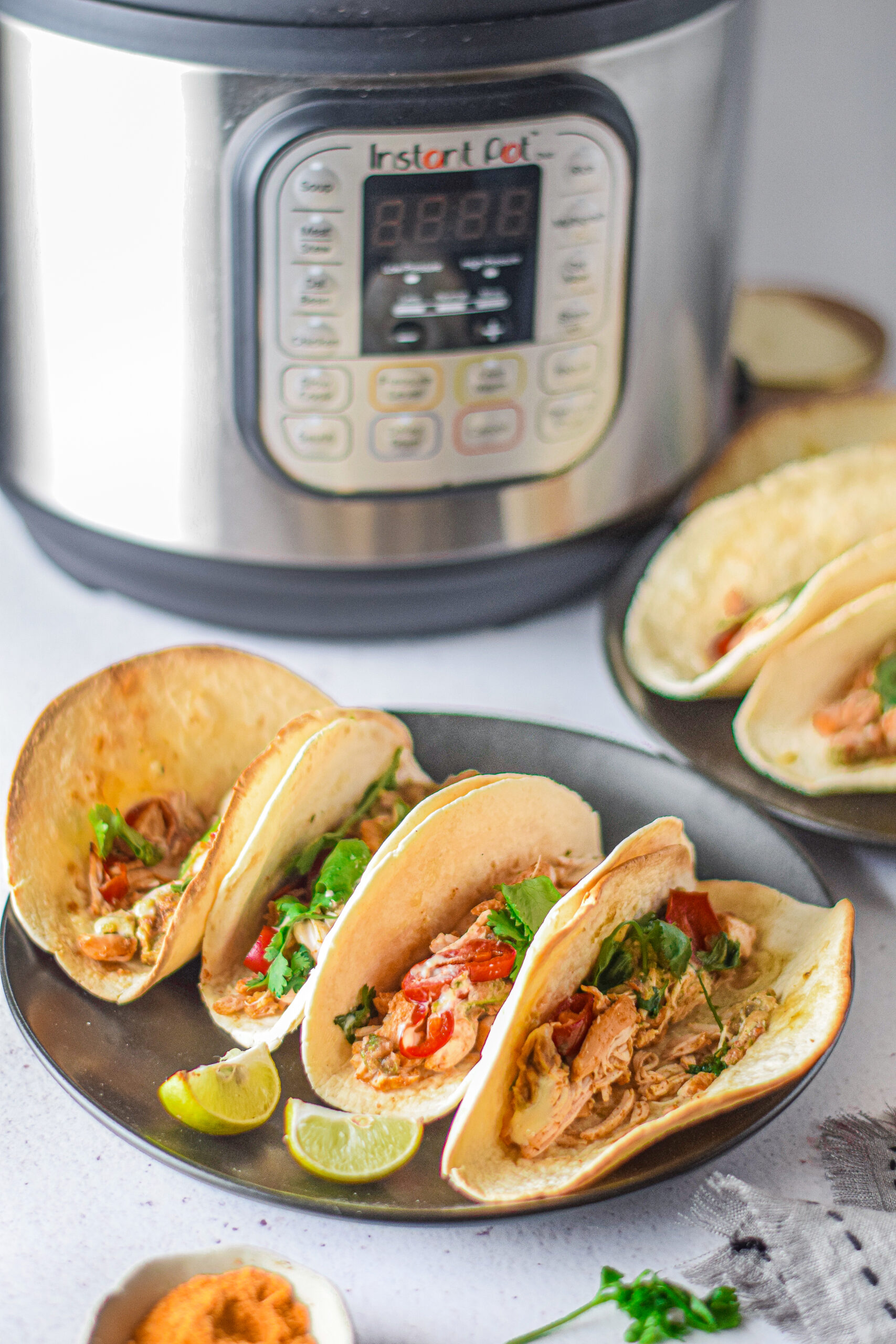Tacos in front of an instant pot.