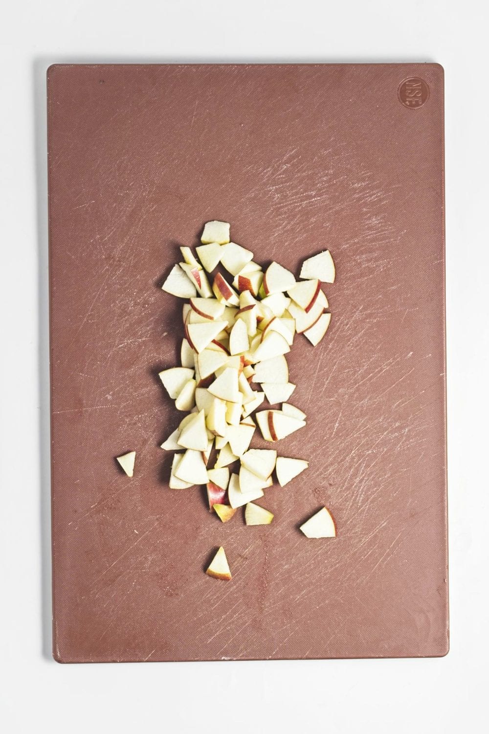 Chopped apples on a cutting board.