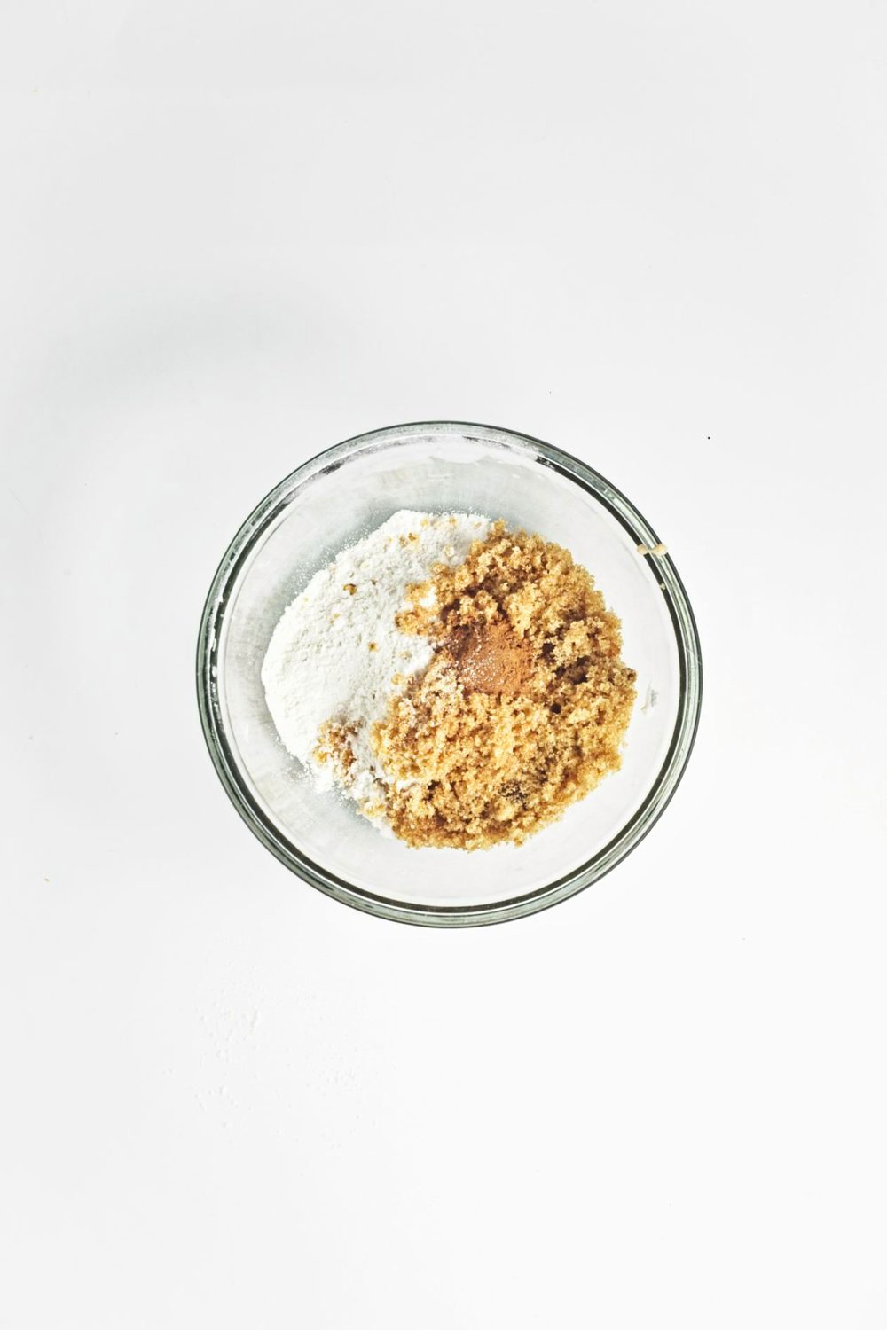 Ingredients for the crumb topping for apple muffins in a glass bowl.